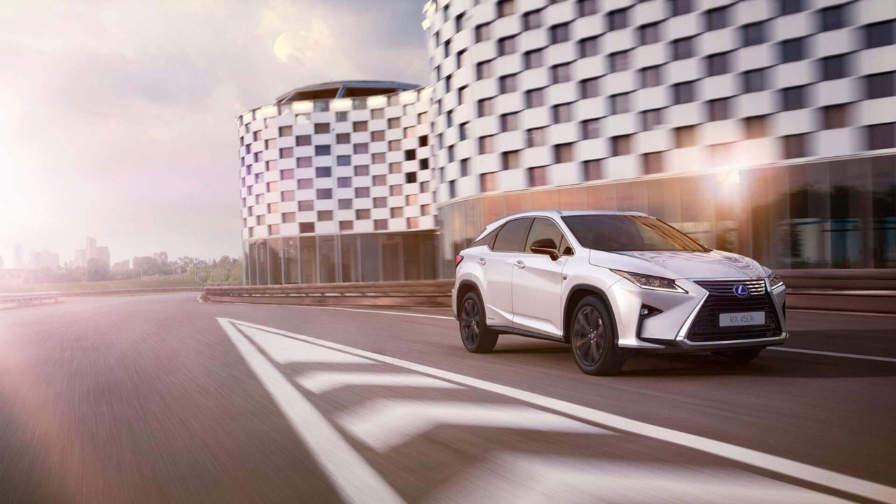Side view of the Lexus UX driving on a road